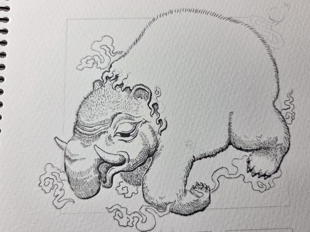 洋伯が万年筆で妖怪獏のペン画を描いている。制作途中の写真