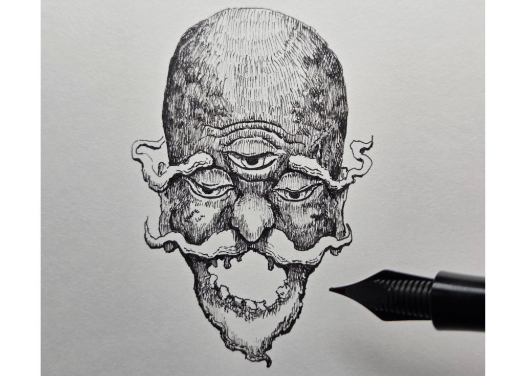 万年筆で描き始めた妖怪海の怪のイラストの模様を入れて目を入れる