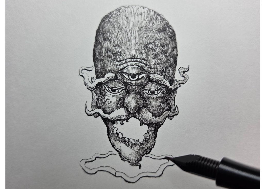 万年筆で描き始めた妖怪海の怪のイラストの下にしめ縄を描いていく